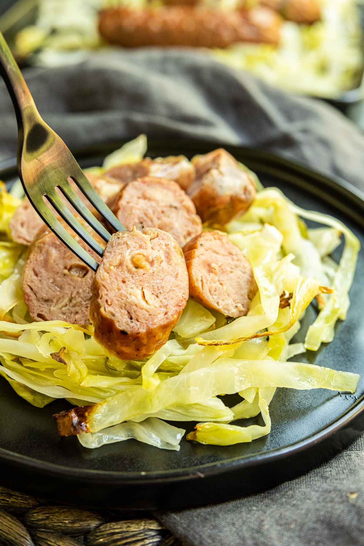 Sheet Pan Sausage and Cabbage on a fork