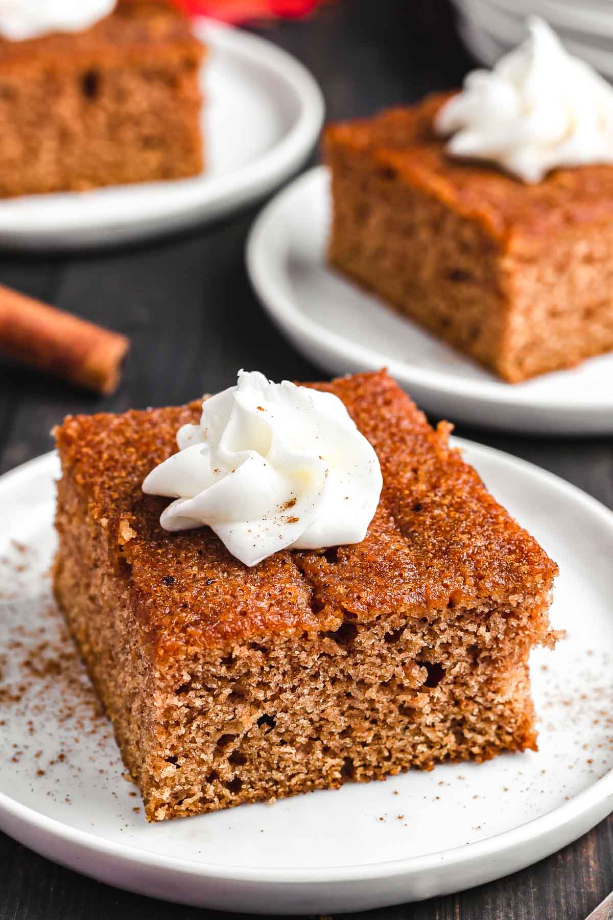 Apple Spice Cake on a plate with whipped cream