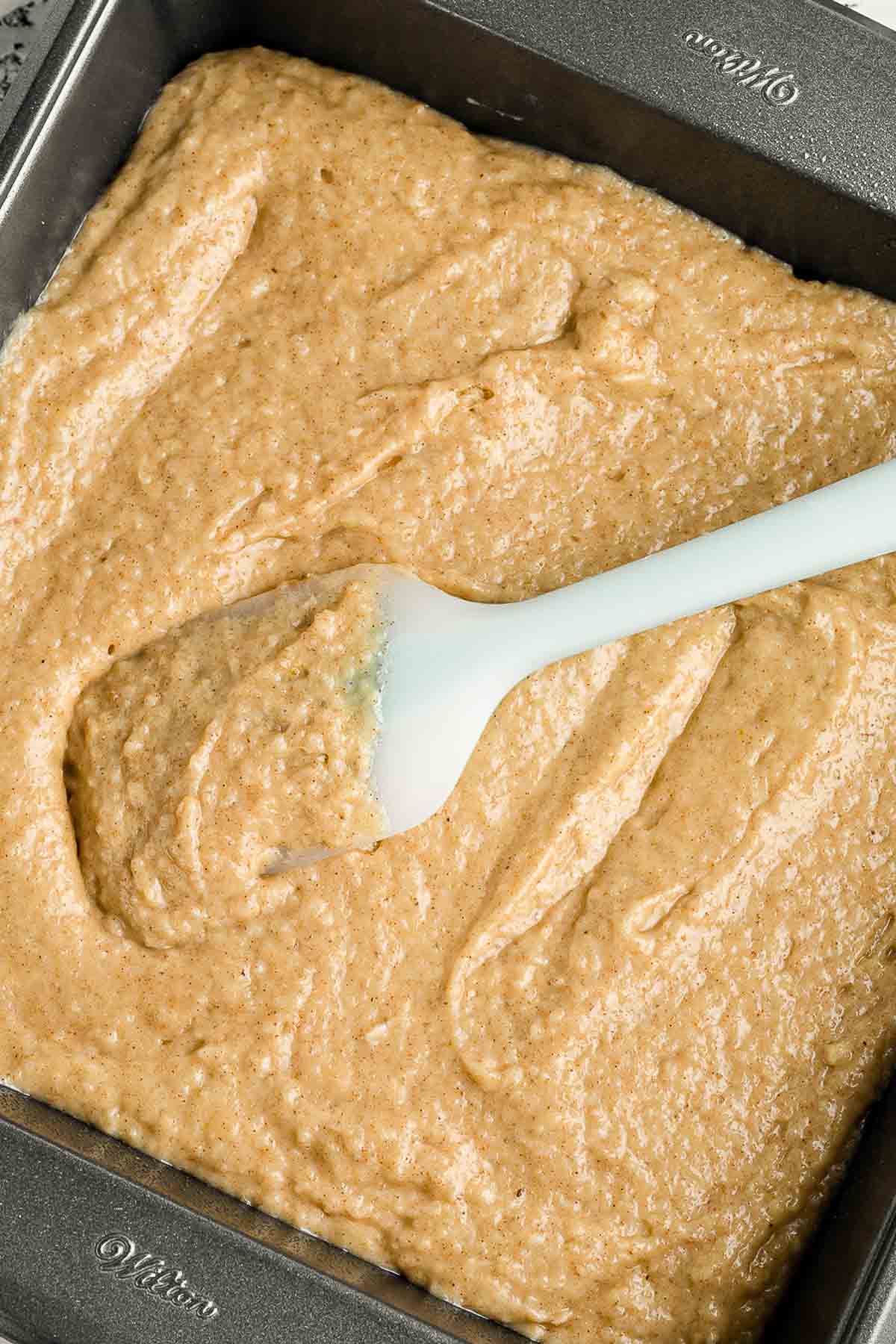 Apple Spice Cake batter in pan with spatula
