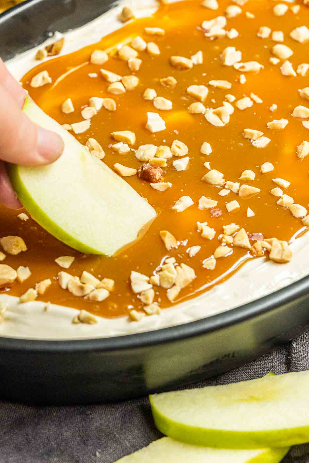 Caramel Apple Dip in bowl topped with caramel