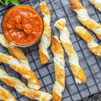 Cheese Twists on cooling rack with dipping sauce