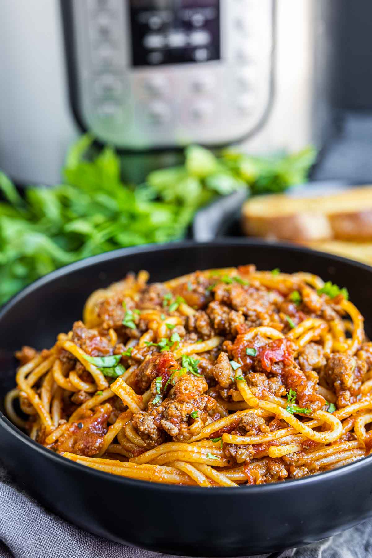 Instant Pot Spaghetti in a black bowl with Instant Pot