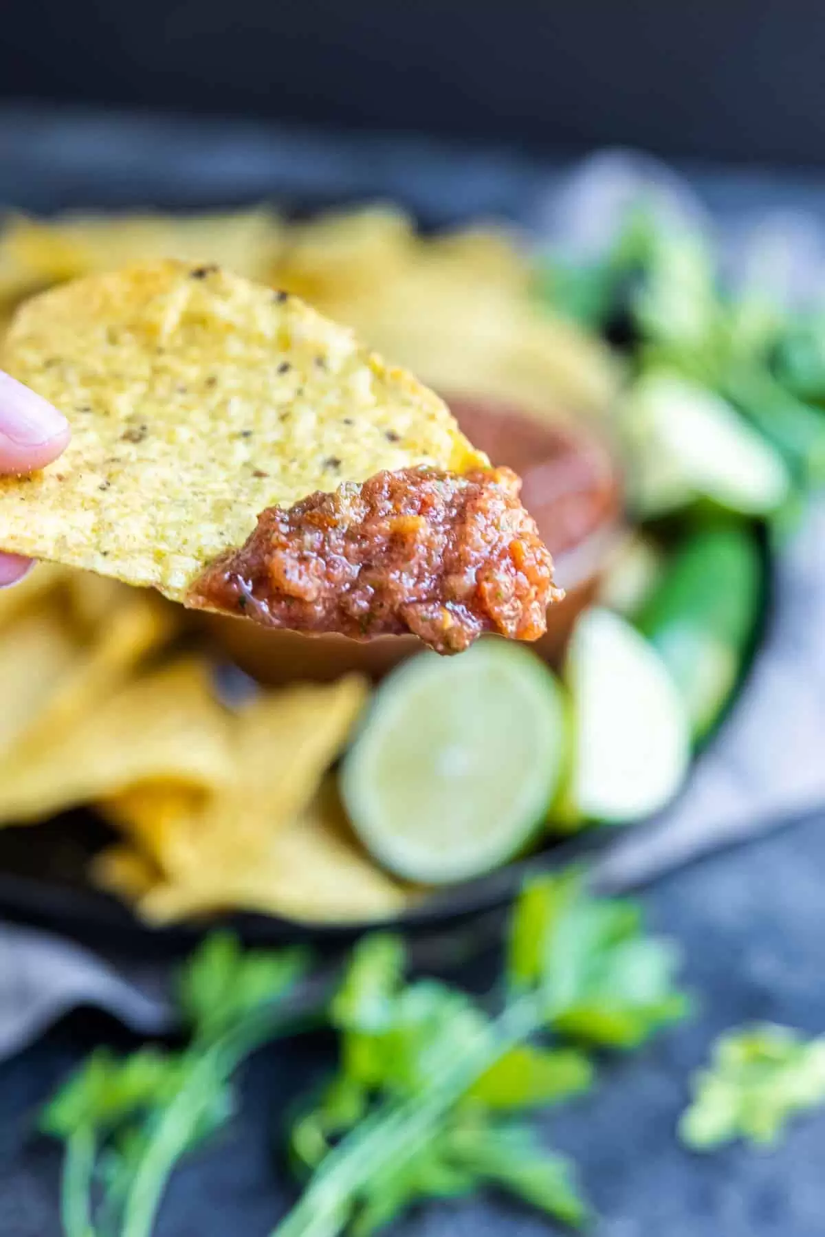holding a tortilla chip with Restaurant Style Salsa