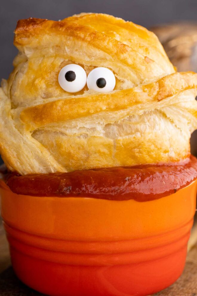 Halloween Baked Cheese mummy dunked in sauce