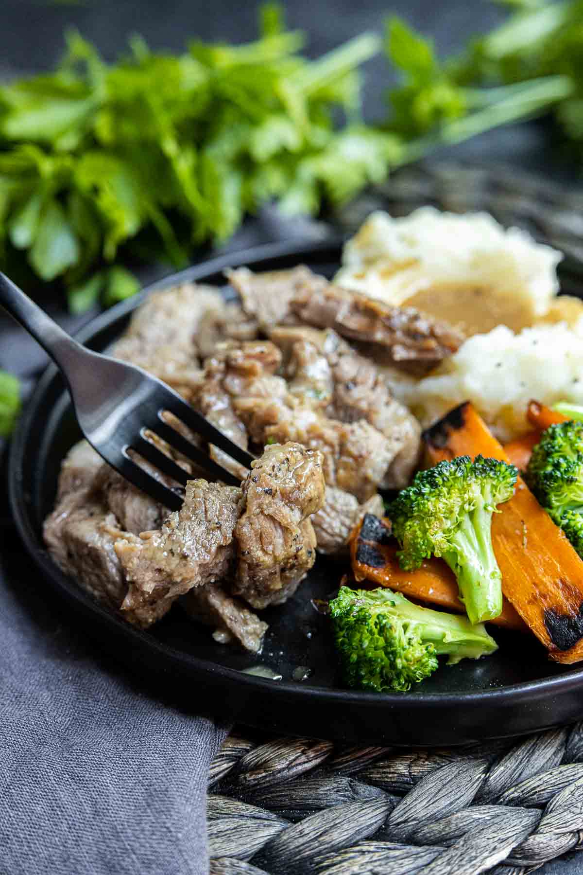 Instant Pot Pork Roast on a plate with veggies and fork