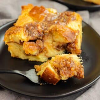 Pecan Pie Bread Pudding on a black plate with black fork