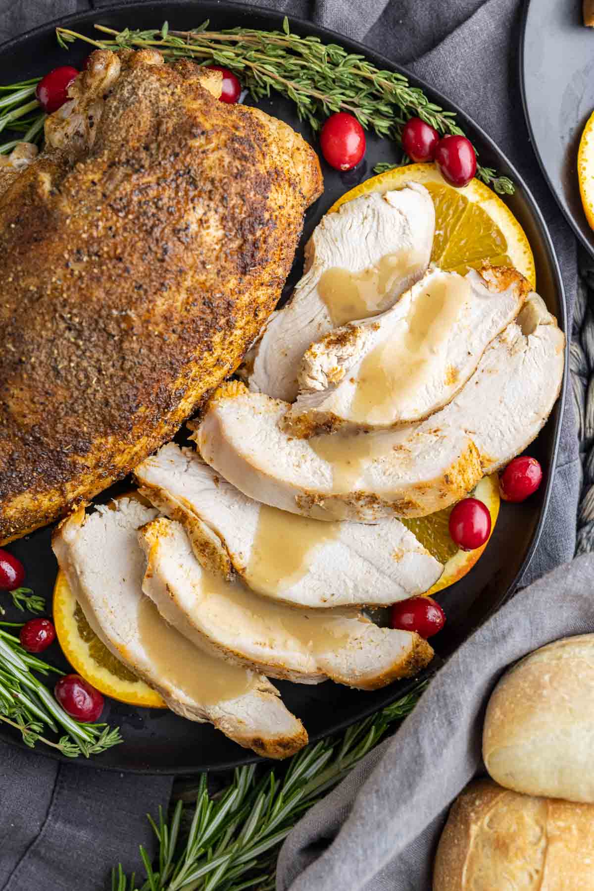 Slow Cooker Turkey Breast with gravy poured on sliced turkey breast