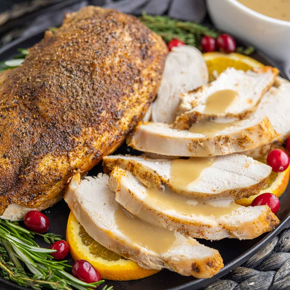 sliced Slow Cooker Turkey Breast on a plate with gravy
