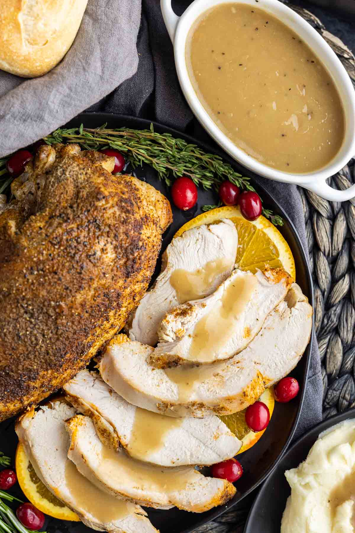 Turkey Gravy on turkey next to white gravy boat