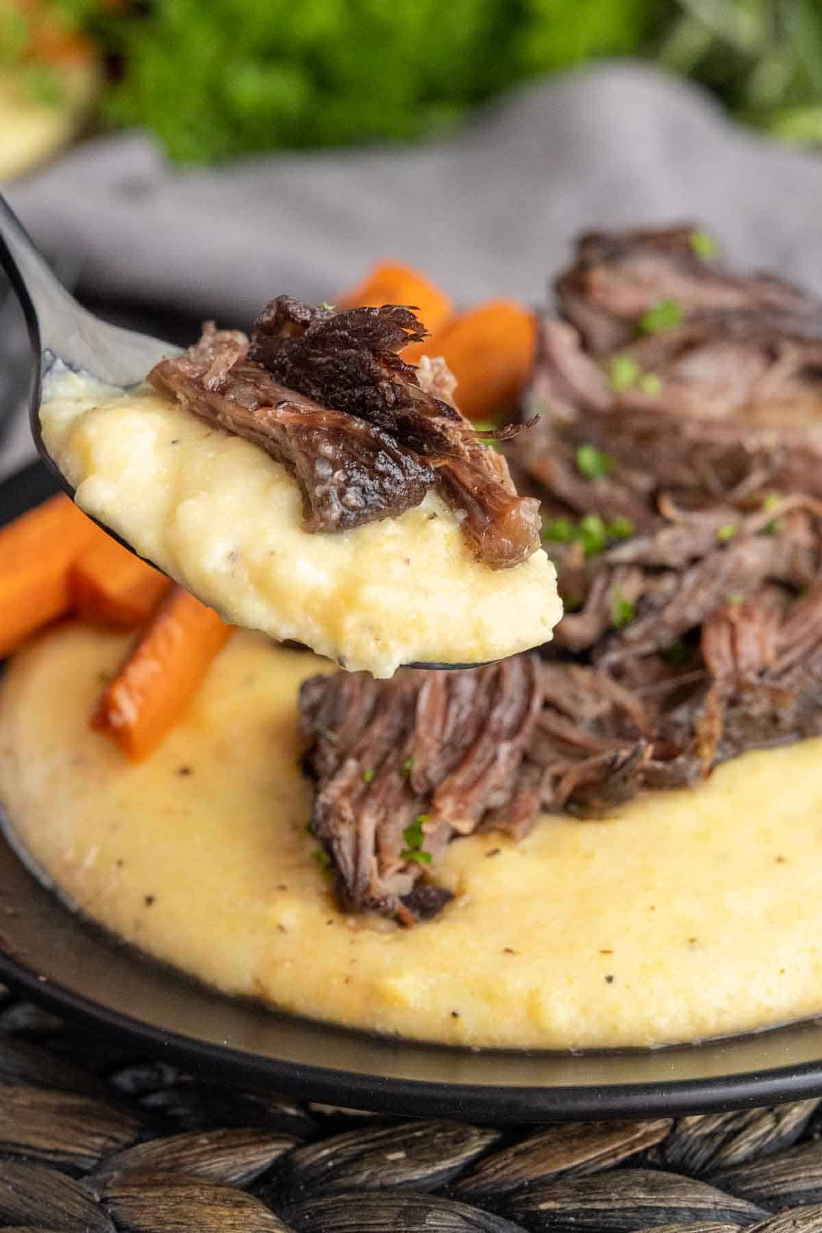 Creamy Polenta and braised ribs on a spoon