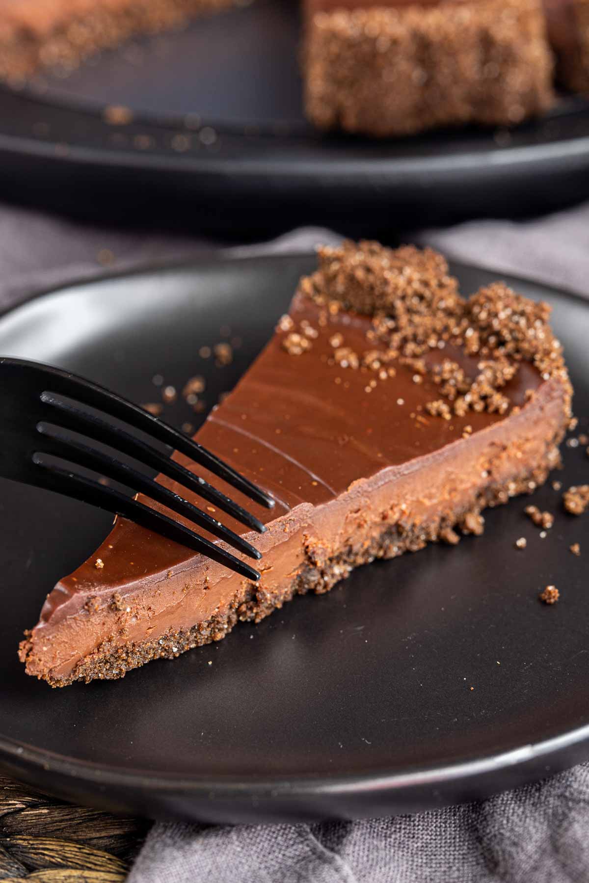 black fork in a slice of Decadent Chocolate Tart