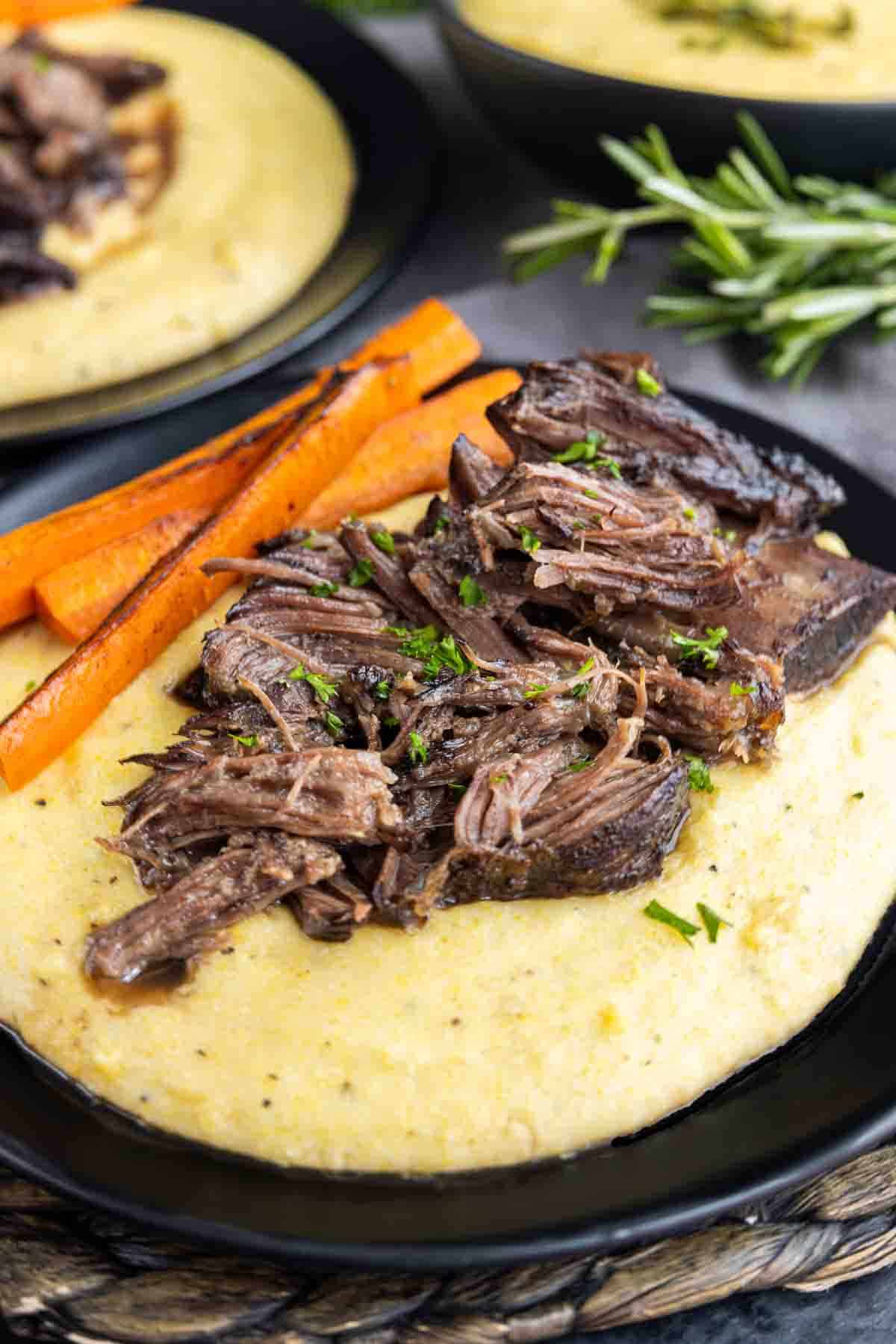 Red Wine Braised Short Ribs and creamy polenta on a plate
