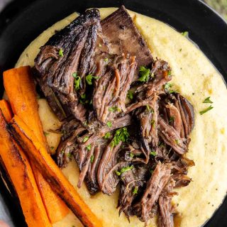 Red Wine Braised Short Ribs on a plate with creamy polenta