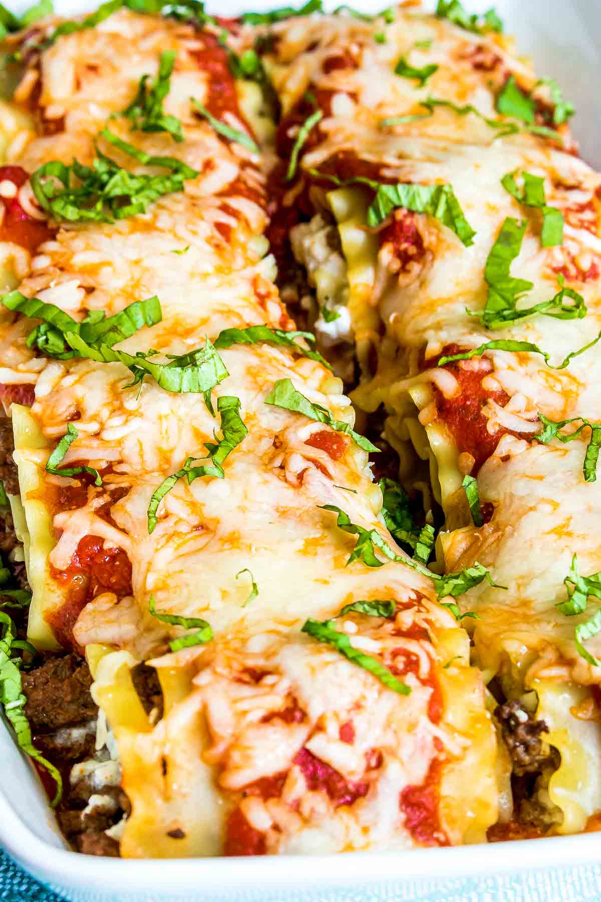 Lasagna Roll Ups topped with sauce and cheese