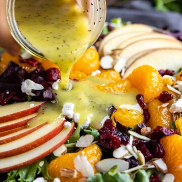 pouring Citrus Poppy Seed Dressing on a Mandarin Orange Salad