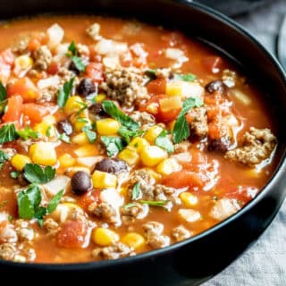 a black bowl filled with taco soup slow cooker