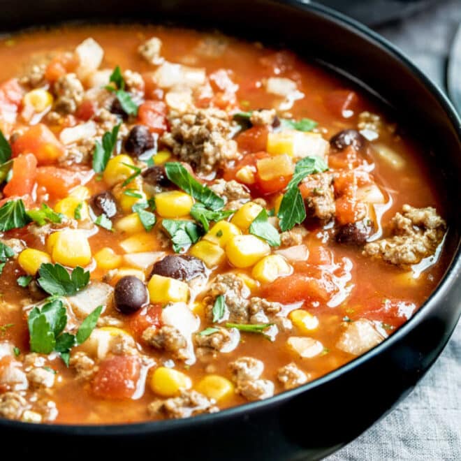 a black bowl filled with taco soup slow cooker