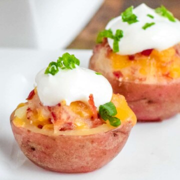 Two mini Irish potato bites on a white plate