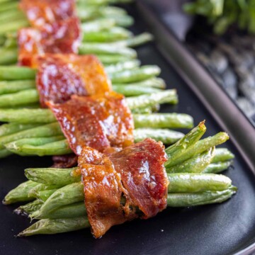 Bacon Wrapped Green Beans on a black platter