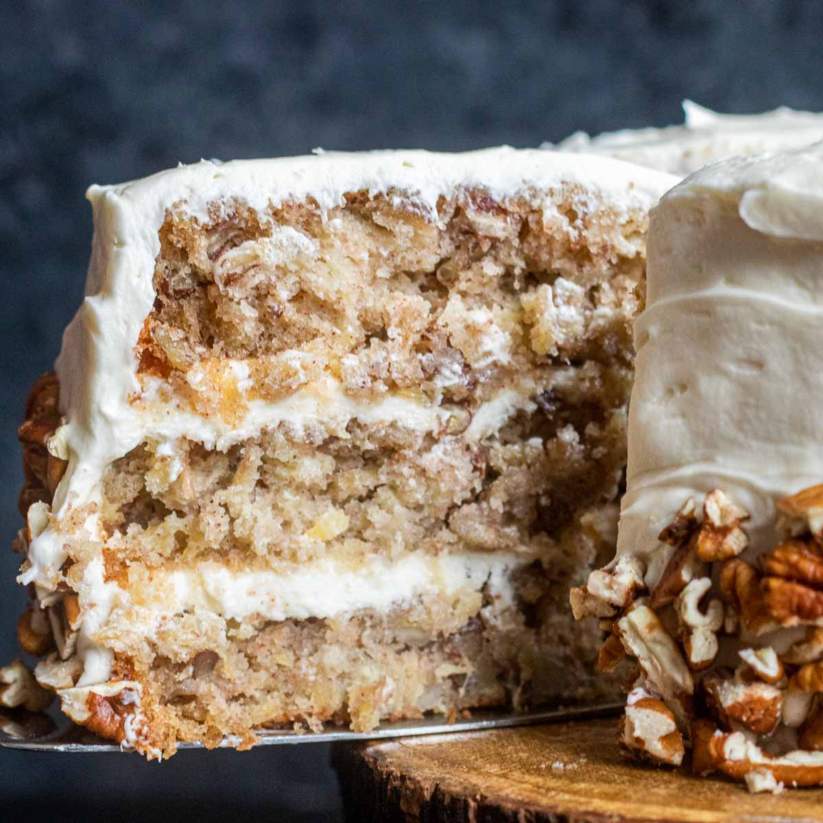 slice of hummingbird cake being removed from a full cake
