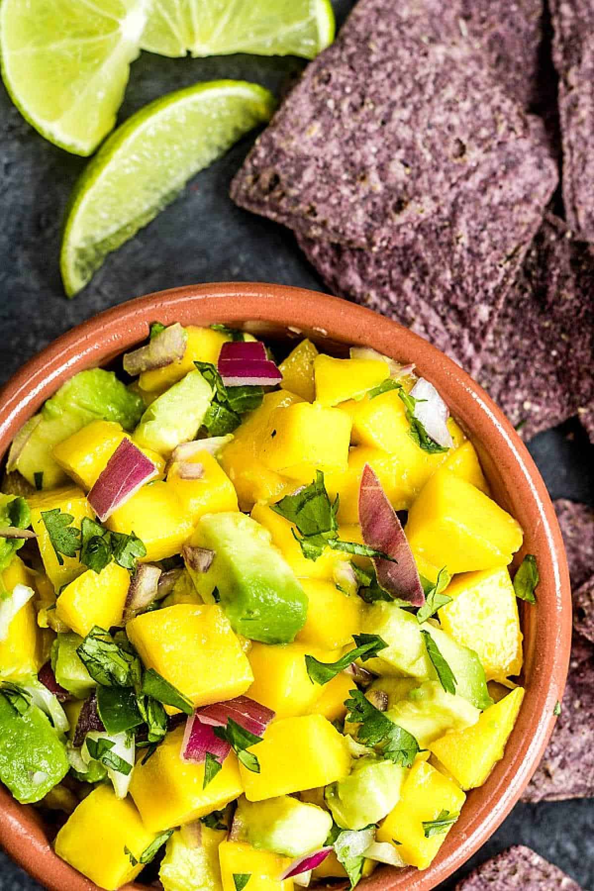 bowl with Mango Salsa with blue tortilla chips