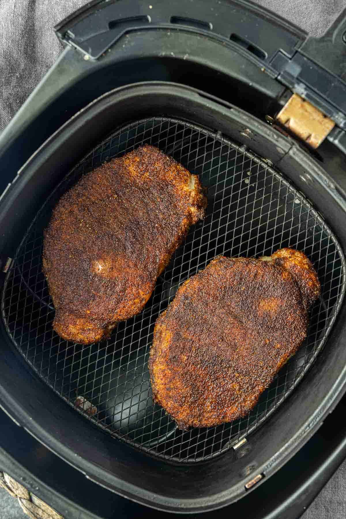 cooked Air Fryer BBQ Pork Chops in air fryer basket