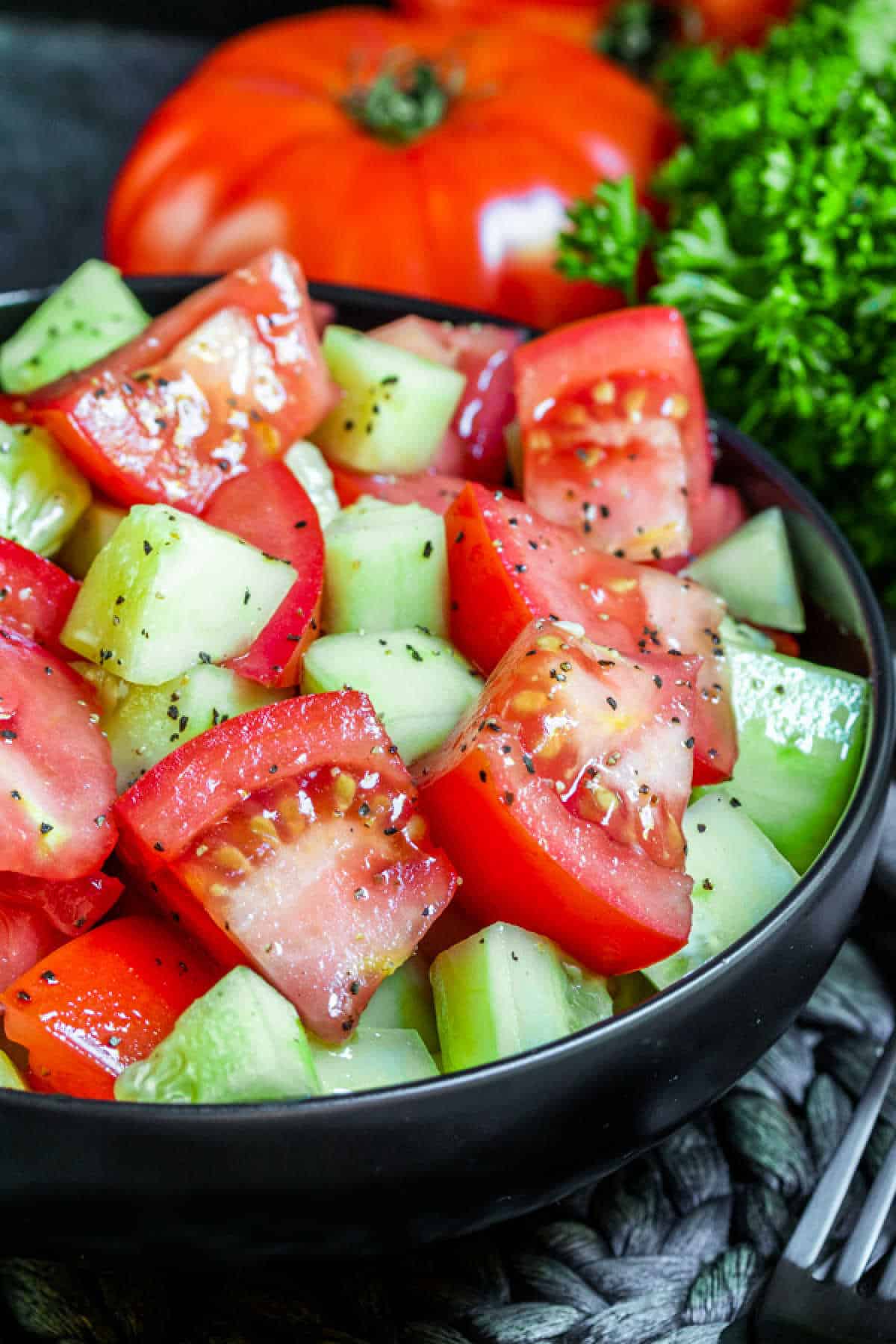 black bowl filled with Tomato Cucumber Salad