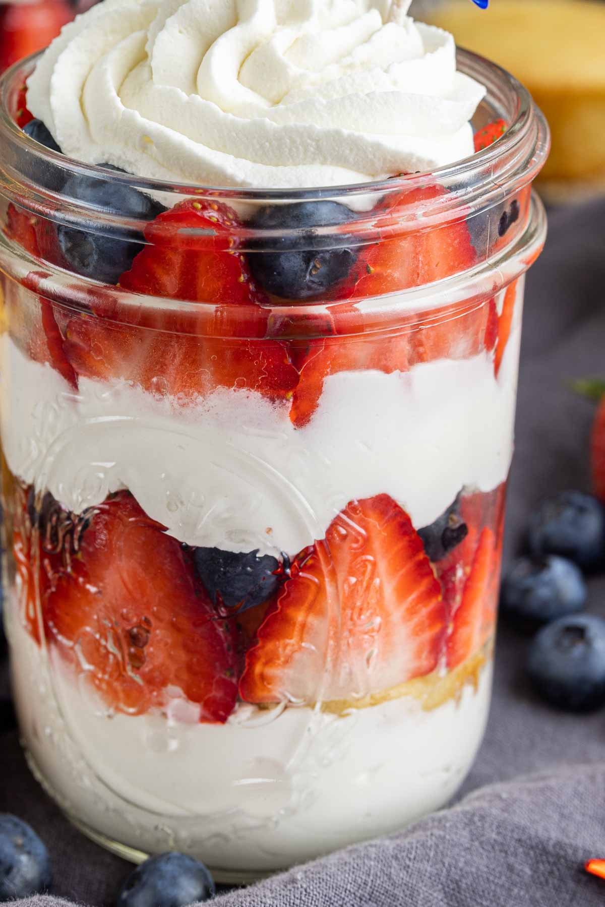 close up of layers of fresh fruit and whipped cream