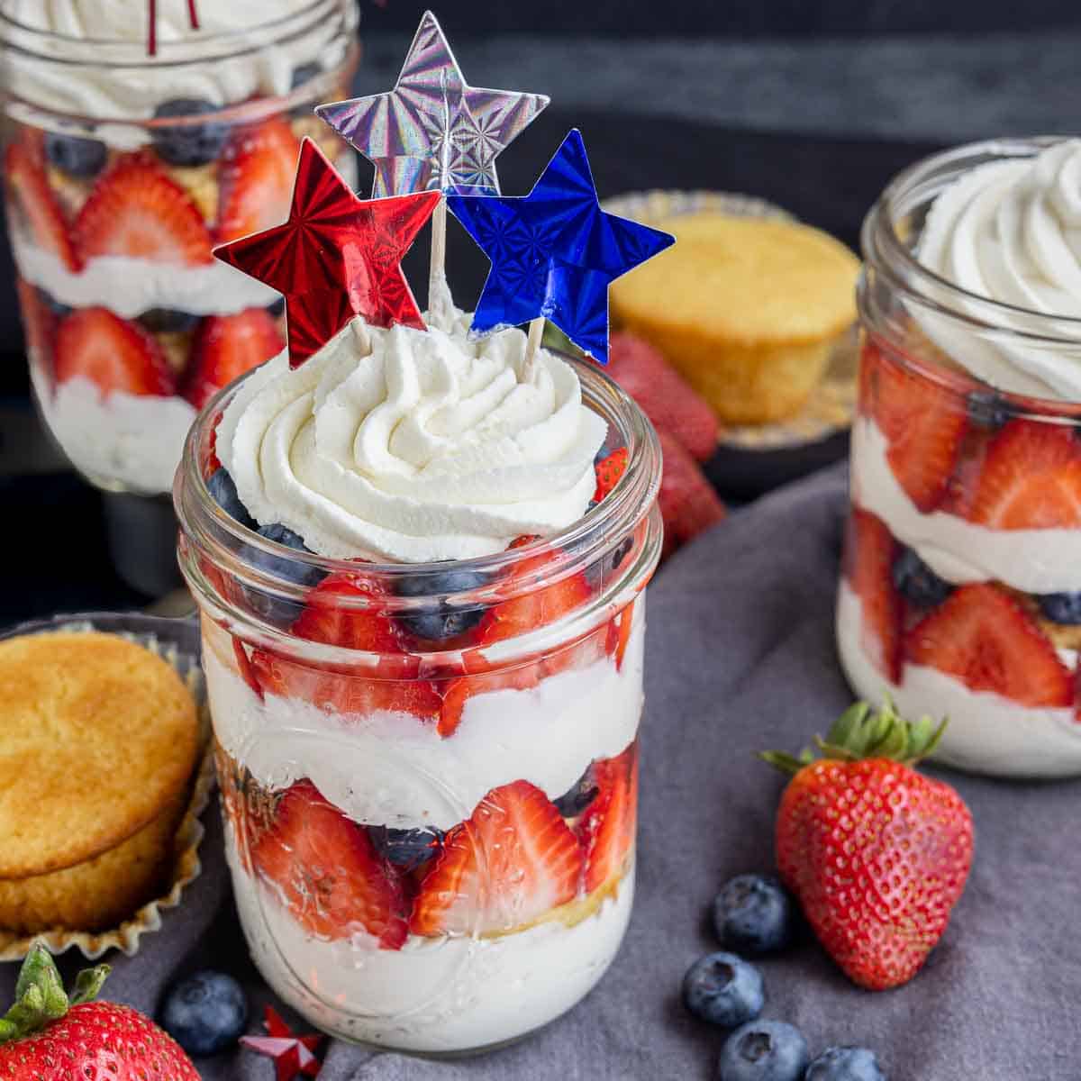cupcakes in a jar with fresh fruit and whipped cream