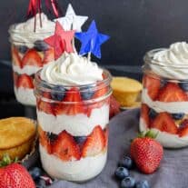 cupcakes in a jar with fresh fruit and whipped cream