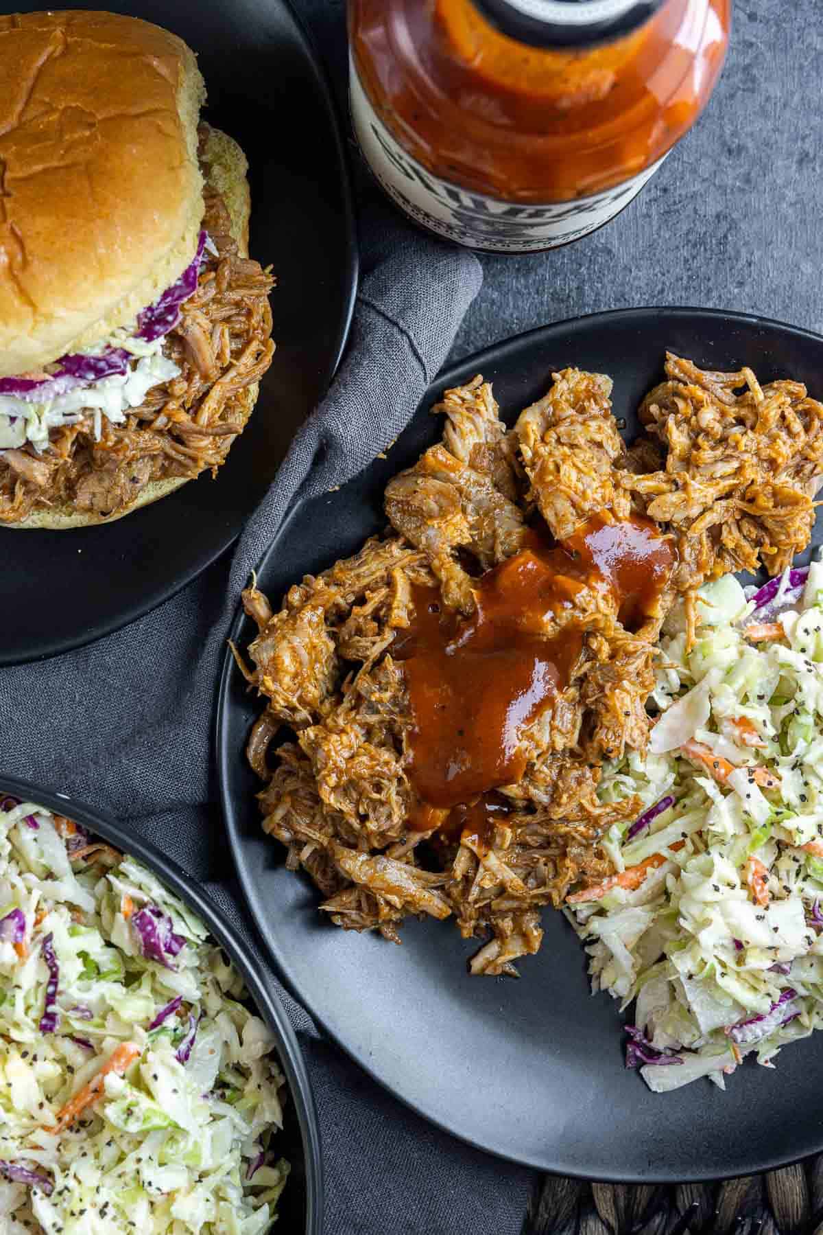Slow Cooker BBQ Pulled Pork on a plate with coleslaw and slider