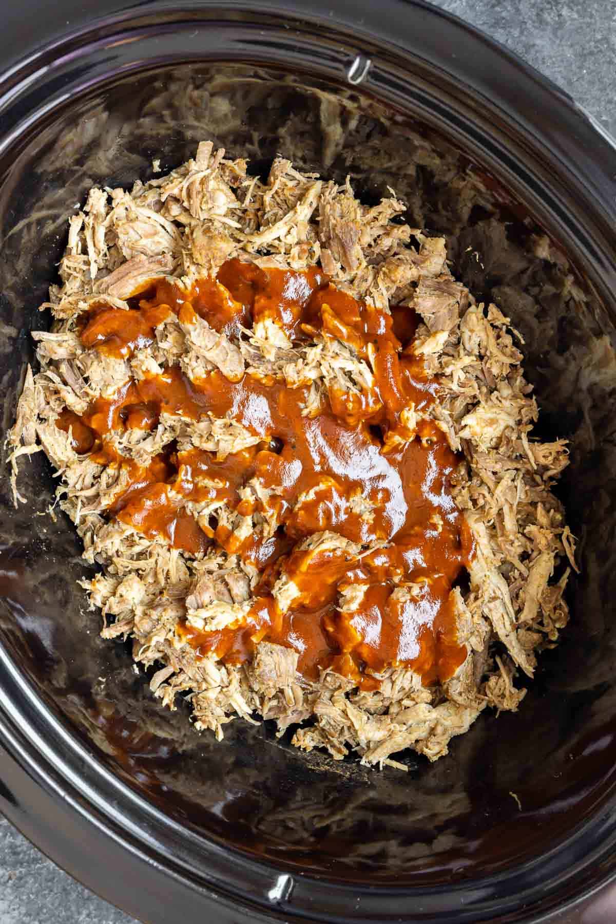 shredded Slow Cooker BBQ Pulled Pork in slow cooker with bbq sauce