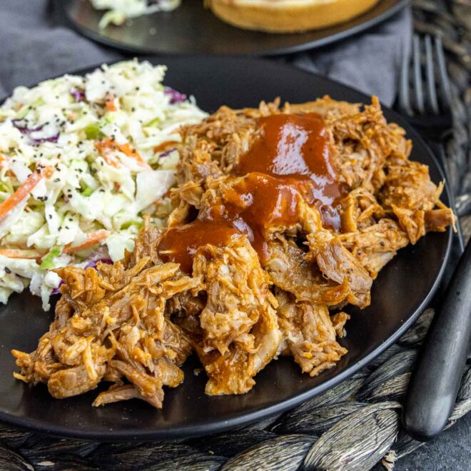 black plate with Slow Cooker BBQ Pulled Pork and coleslaw