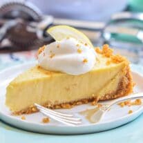Lemon Icebox Pie slice on a plate with fork laying on it