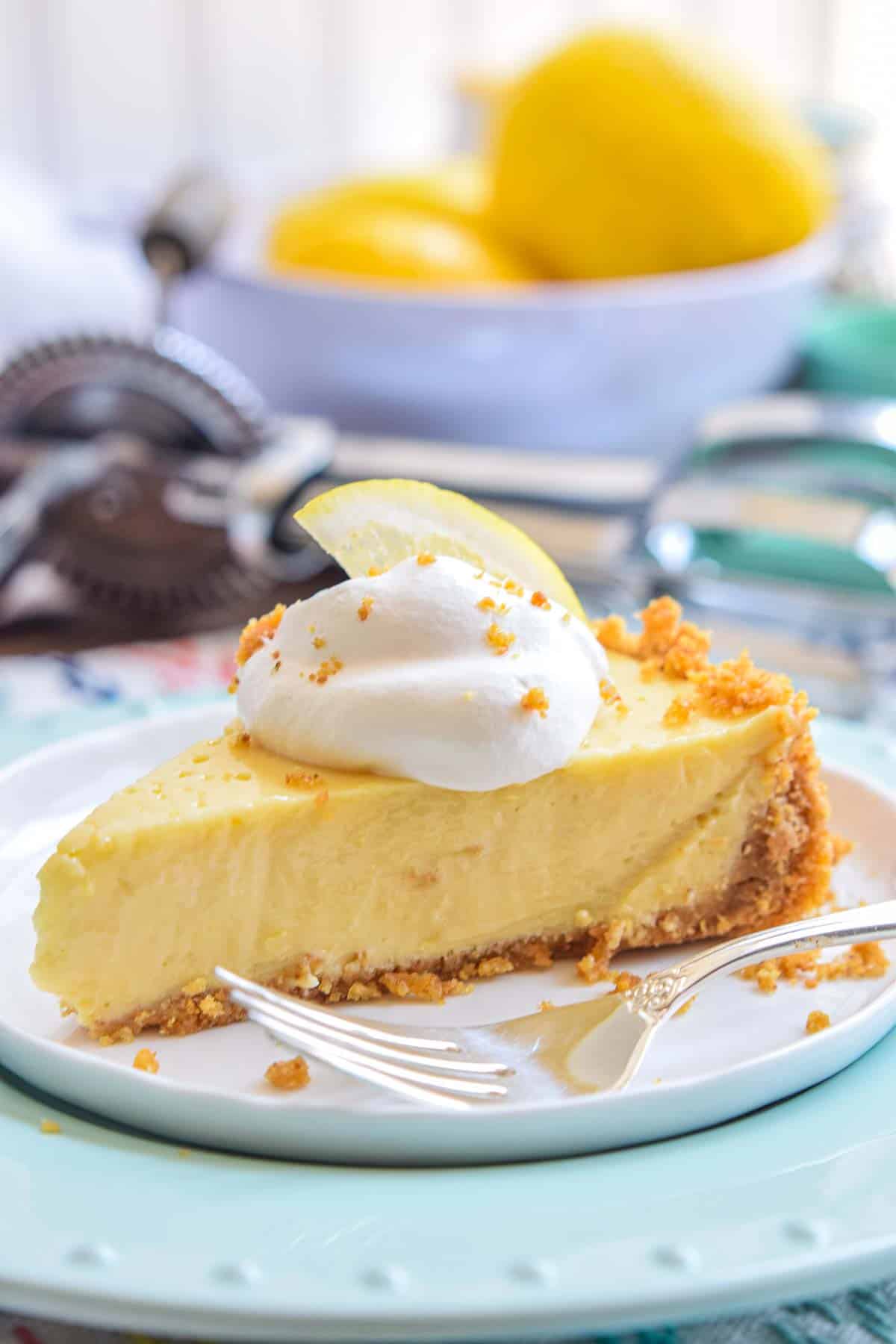 Lemon Icebox Pie slice on a plate with fork next to it