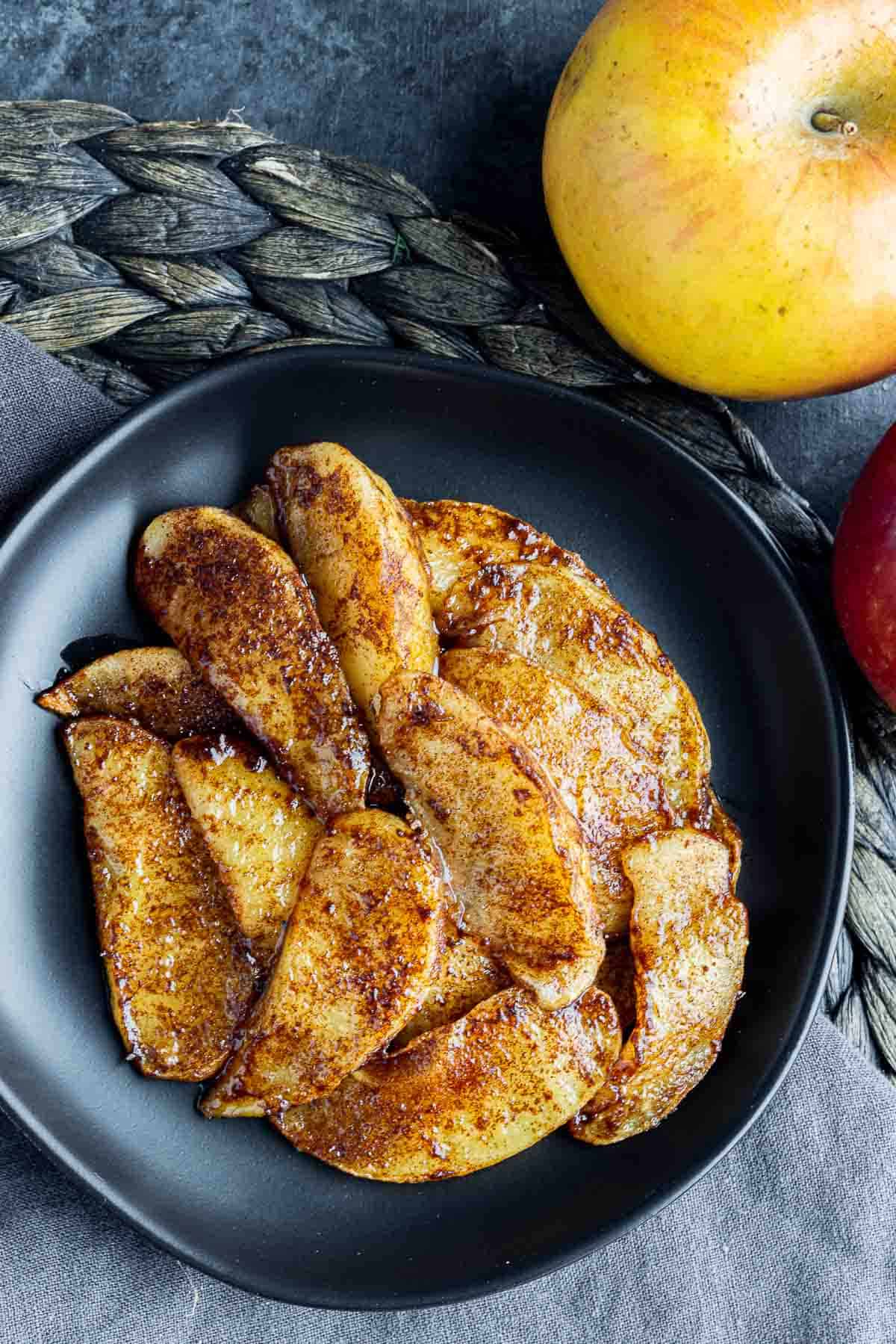 Air Fryer Baked Apple Slices on a plate with a apple on the side