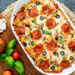 pizza casserole in white casserole dish