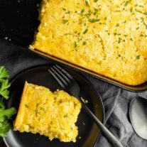 Creamed Corn Casserole on a black plate and fork