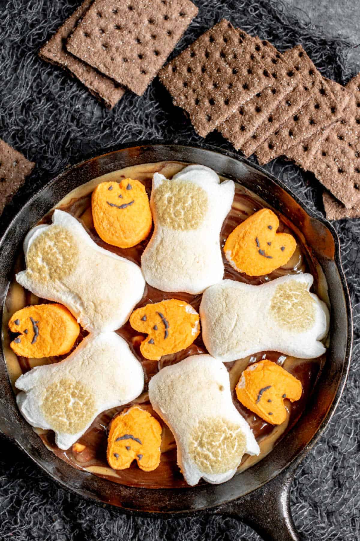 skillet with Halloween Smores Dip and chocolate graham crackers