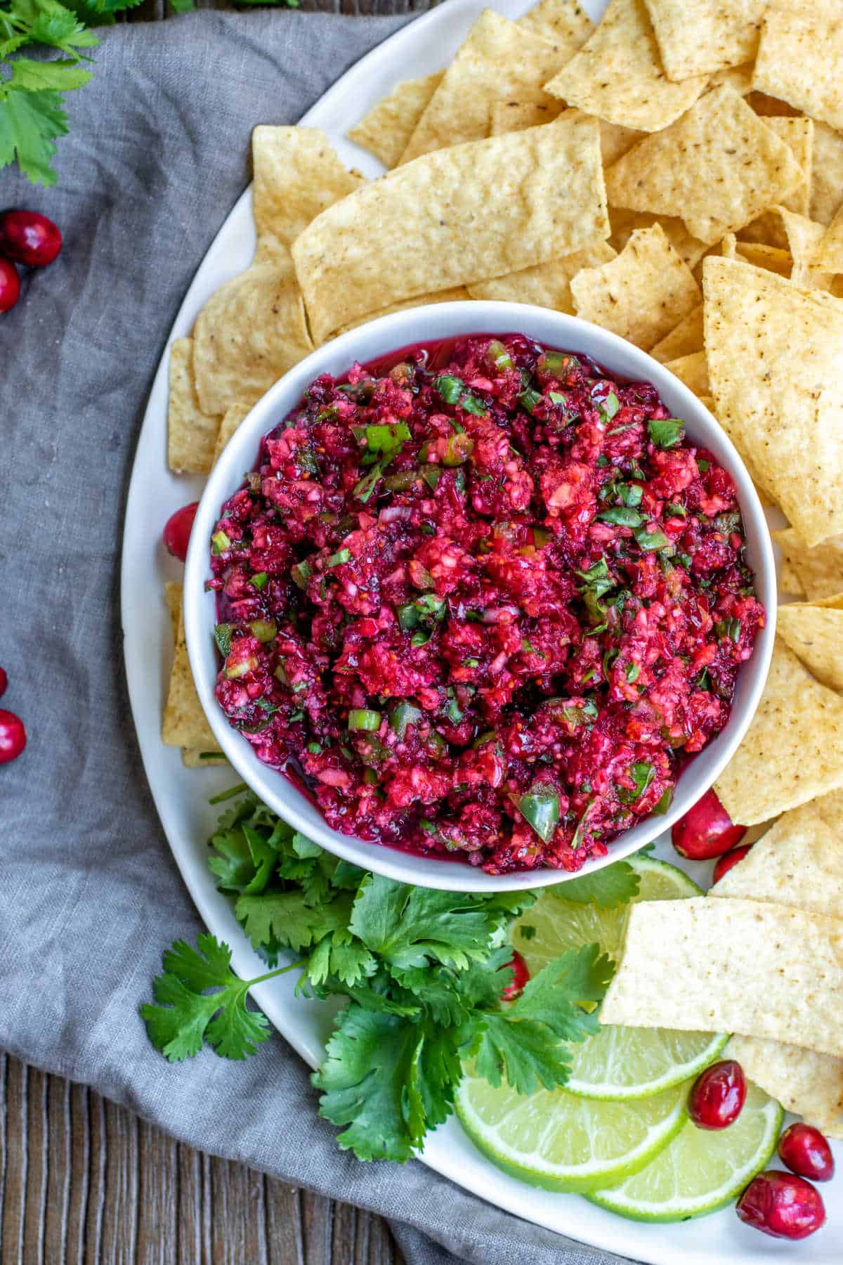 Cranberry Salsa in a white surrounded by tortilla chips
