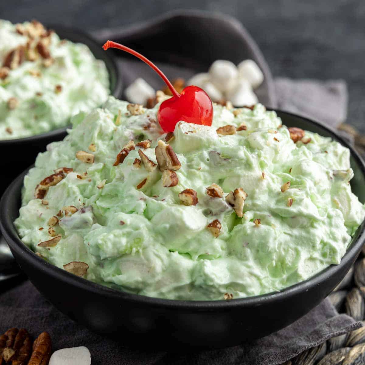 Watergate Salad in a bowl with a cherry on top