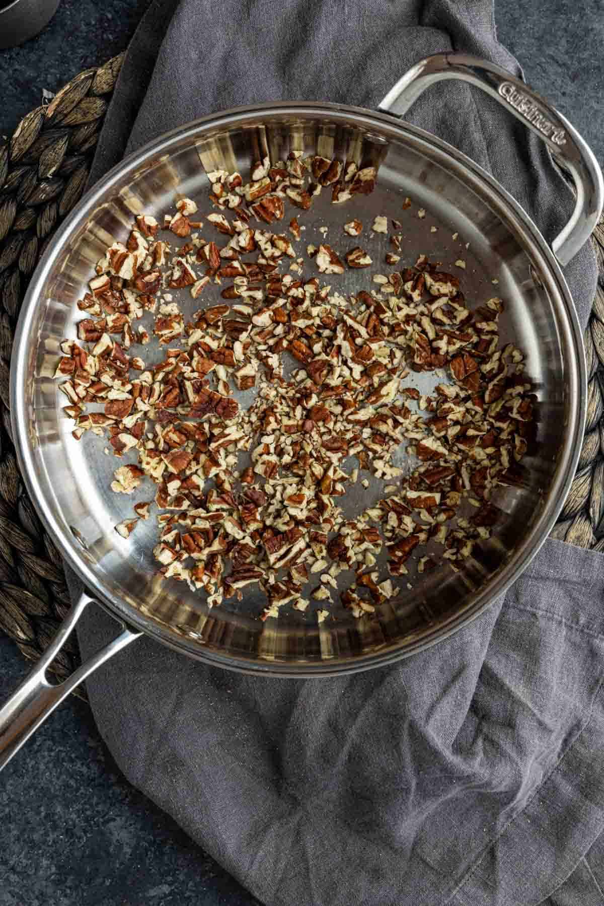 toasted chopped pecan in a skillet to make Pecan Rice Pilaf