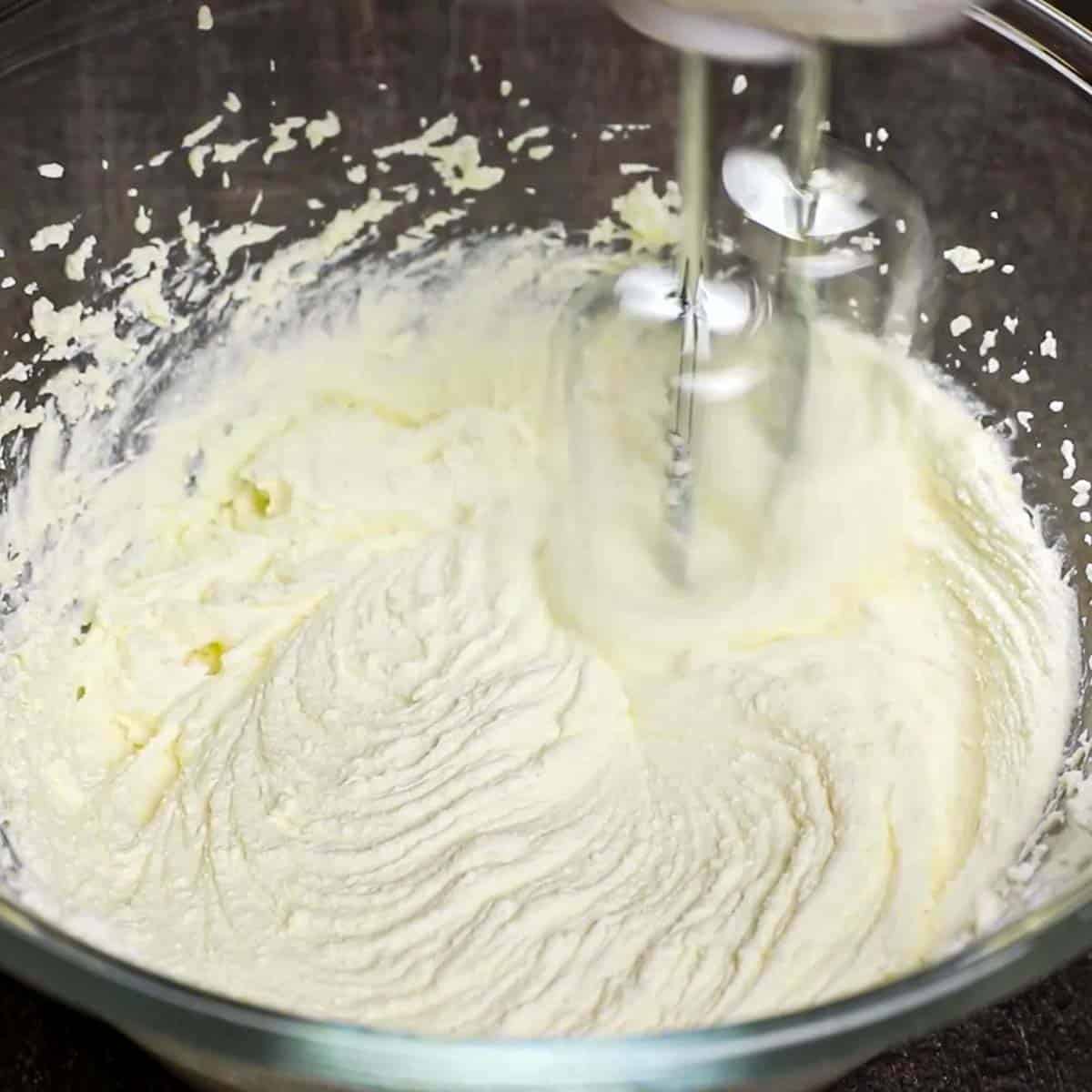 mixing Cannoli Dip ingredients in a glass bowl