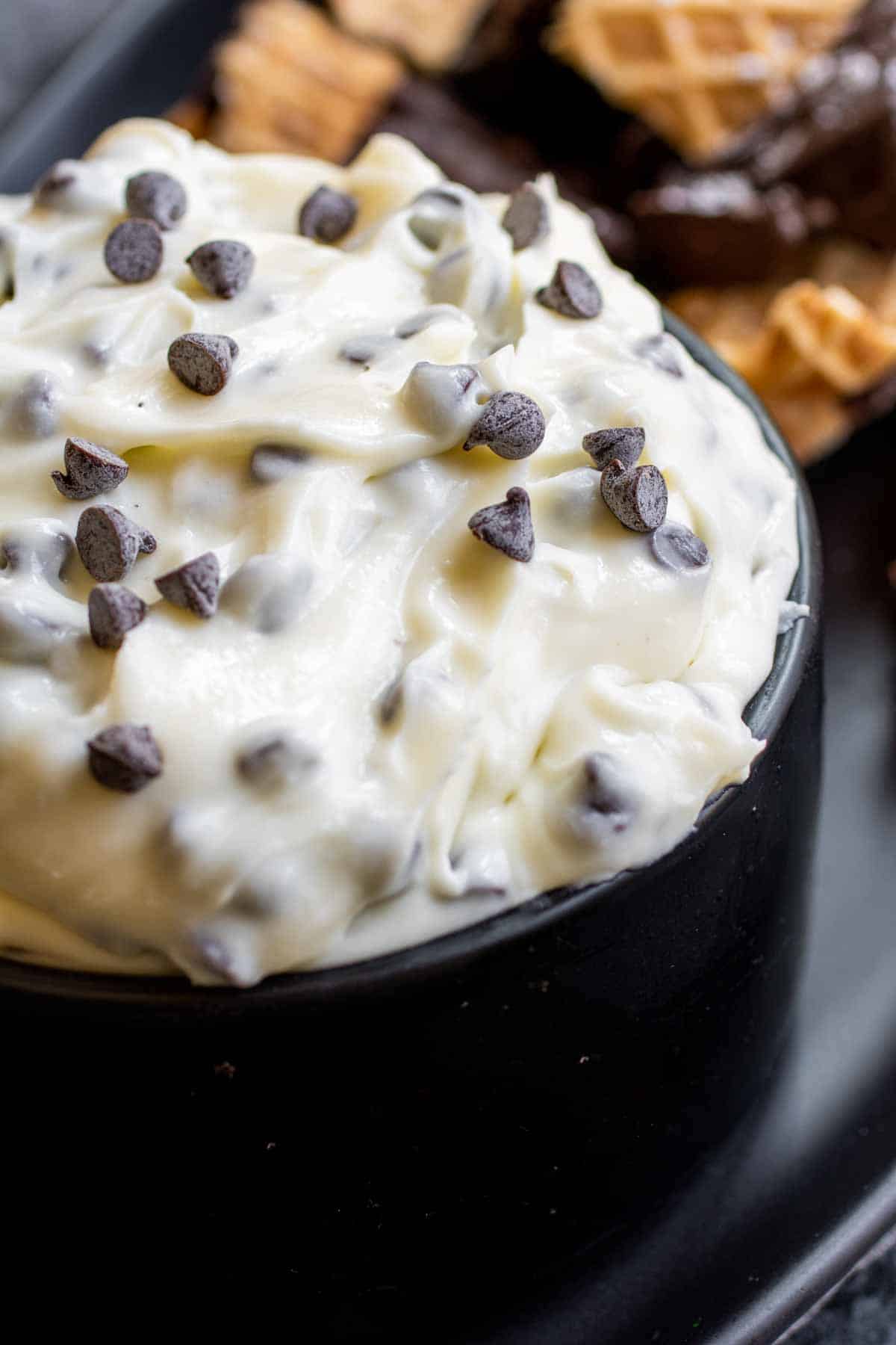 black bowl with Cannoli Dip and mini chocolate chips