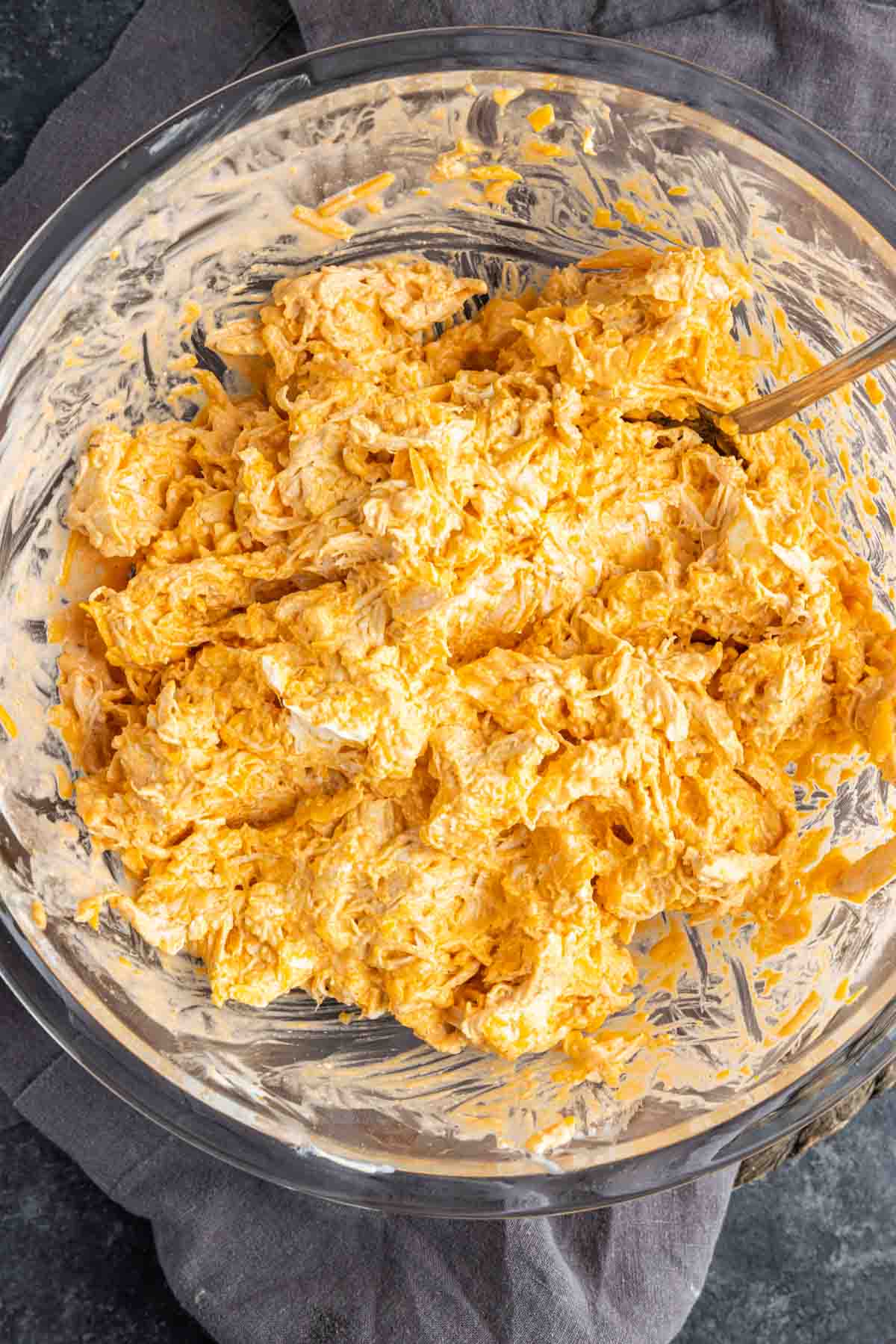 Oven Buffalo Chicken Dip mixture in a glass bowl