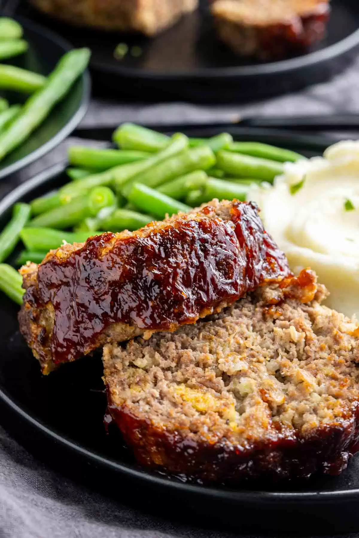 black plate of Air Fryer Meatloaf with green beans