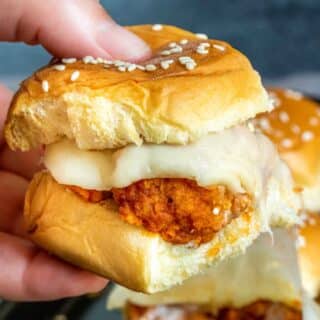 holding buffalo chicken sliders with cheese