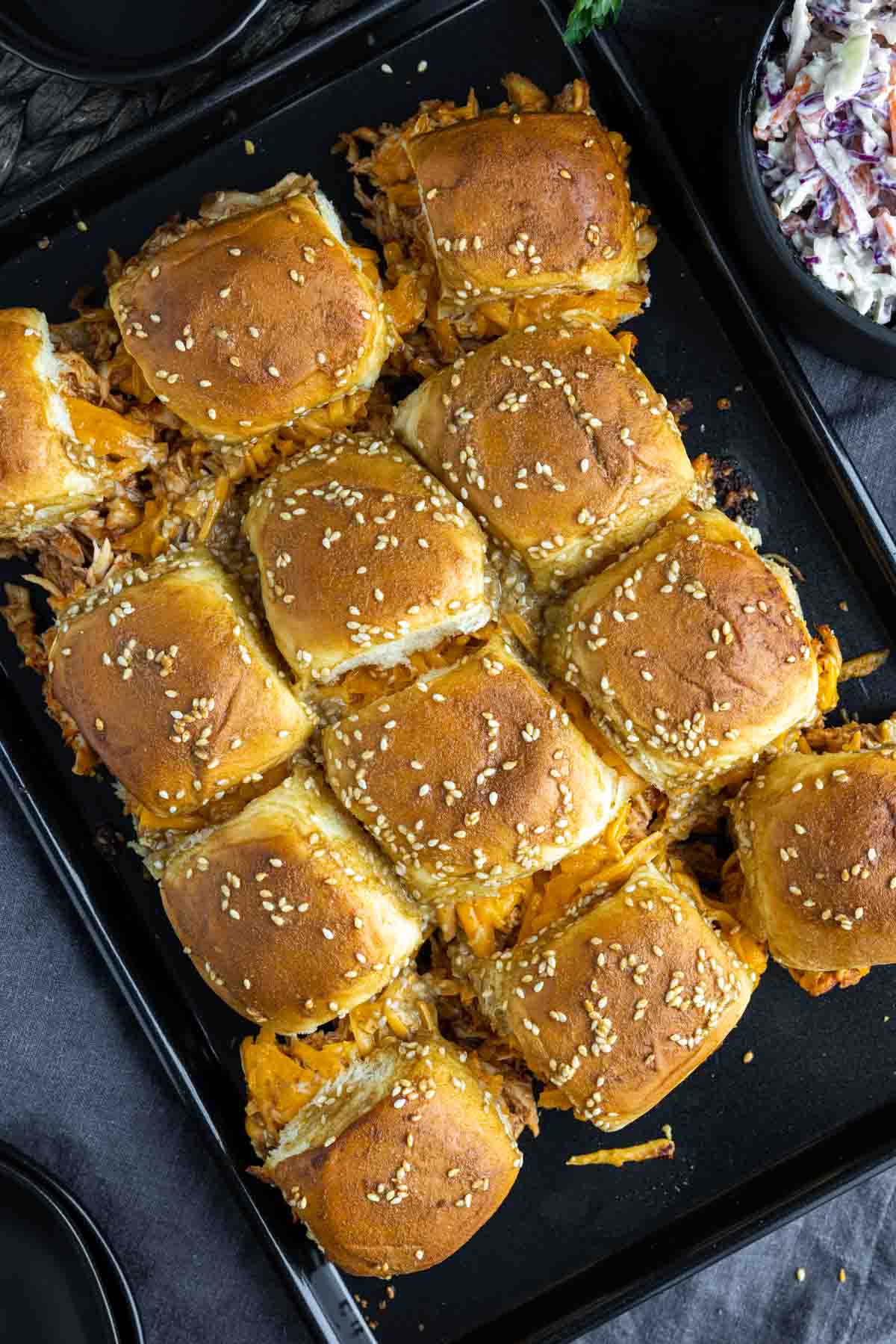baked BBQ chicke sliders on a baking sheet