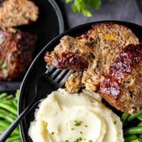 holding a plate with Air Fryer Meatloaf and mashed potatoes