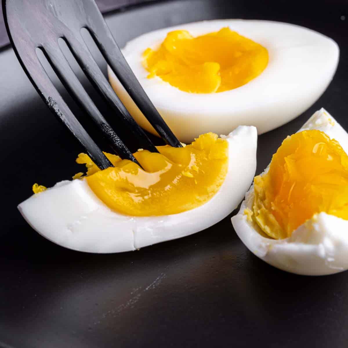 medium boiled egg with fork